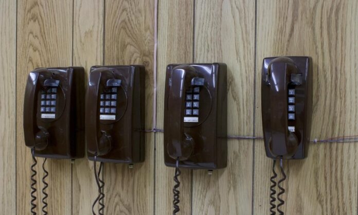 four phones hanging on a wall