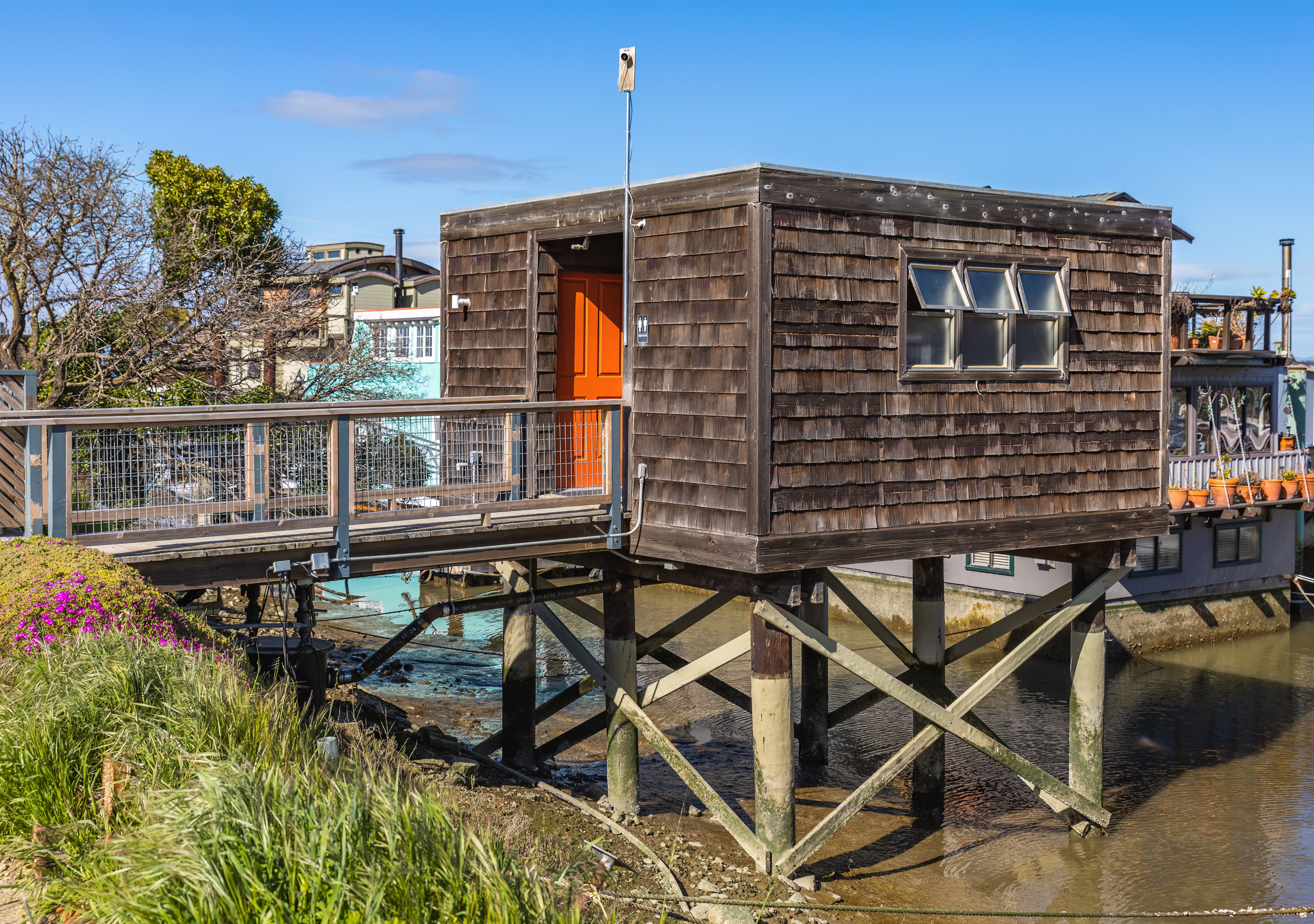 A raised wooden stilt house showing how an elevated home can stand above ground level.