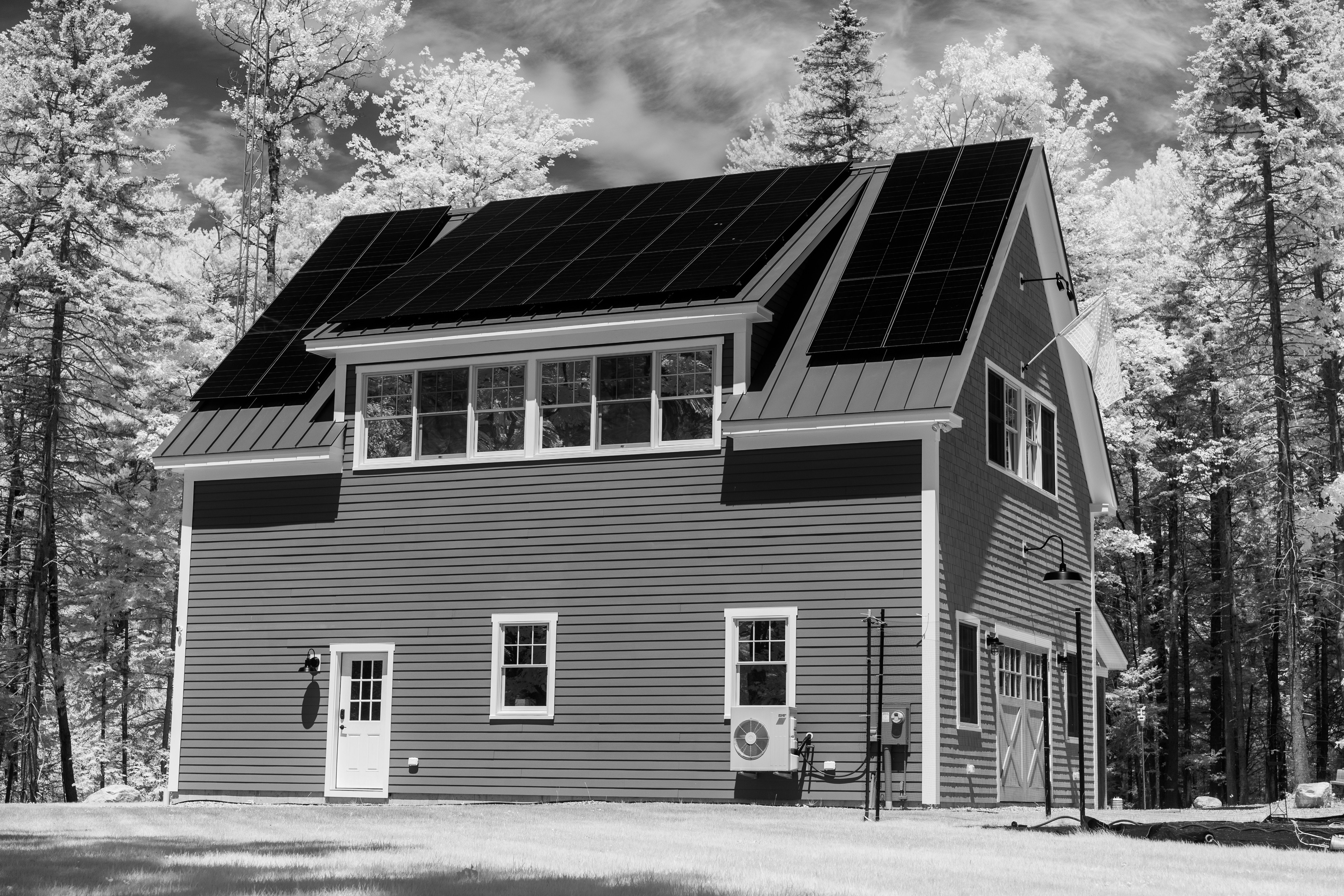 Contemporary home with rooftop solar panels in a forest setting