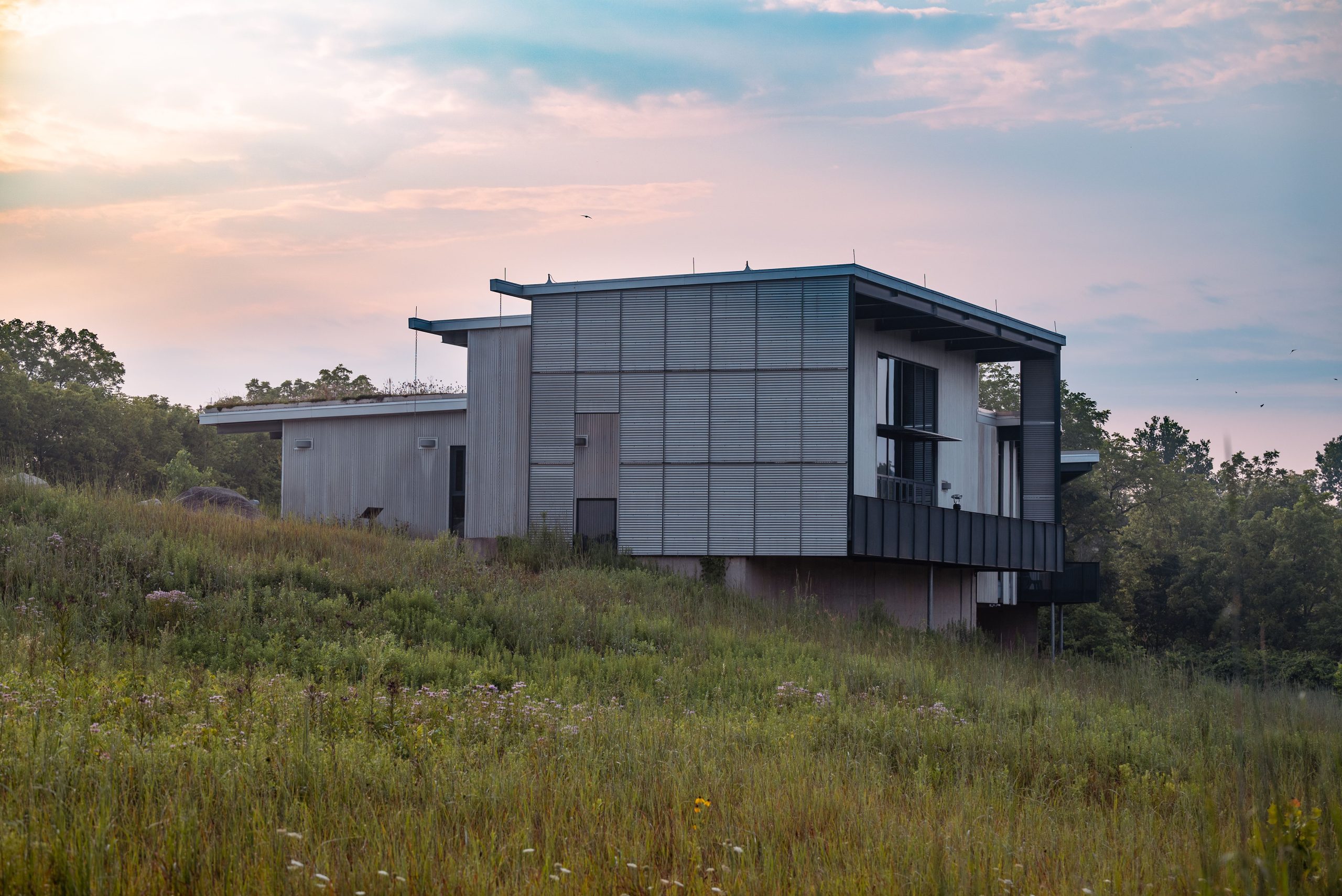 sustainable-modern-home-grassland Contemporary sustainable home surrounded by open grassland at sunset
